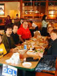 A group of happy DEC collectors around a table, with a blue DCL sign in the foreground.