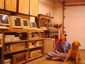 [photo: Debee and Glade sitting on the floor next to small computer row]