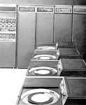 A black and white image of a DECsystem-10, KL10 model A.  Four RP04 disk drives appear in the foreground.