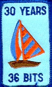 The badge given out at the 30th LCG reunion at DECUS.  The picture shows a sailboat with the letters "30 Years - 36 Bits."